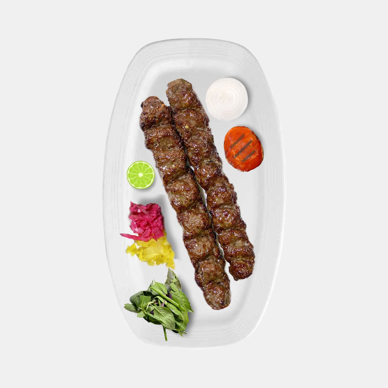 Bonab Kebab and Koobideh Kebab are both popular types of Iranian kebabs, but they have some differences:

Meat Texture: In Bonab Kebab, the meat is chopped manually, whereas Koobideh Kebab uses ground meat.

Size and Shape of the Kebab: Bonab Kebab is wider and thicker than Koobideh Kebab and is usually prepared on larger, wider skewers.

Fat Content: Bonab Kebab typically contains more fat, making it juicier and more flavorful.

Nutritional Value of Bonab Kebab

The chefs of the best kebab restaurant in Rasht explain that Bonab Kebab, due to its use of red meat and fat, contains protein and saturated fats. The protein in the meat is essential for building and repairing body tissues, but it is important to remember that, because of its high fat content, consumption should be moderate. Additionally, if Bonab Kebab is served with bread and fresh vegetables, it can make a relatively complete and nutritious meal.

In Conclusion

Bonab Kebab, with its delicious taste, tender texture, and unique cooking method, is one of the most popular Iranian kebabs, loved by both locals and tourists. Made with fresh meat and simple yet flavorful spices, it offers a unique experience of authentic Iranian kebab. If you enjoy kebabs and want to try a traditional and distinctive version, Bonab Kebab can be an excellent choice.